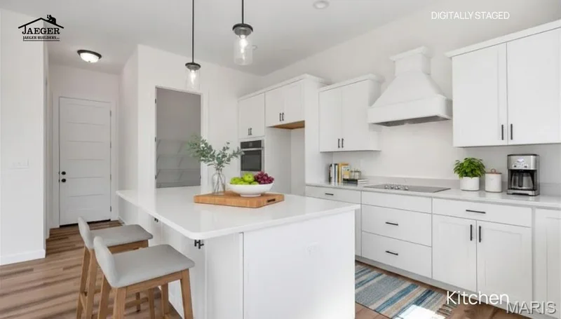 Large island with quartz countertops and upgraded kitchen package including double oven, microwave drawer and hood. (Virtually staged) — 308 Schaper Estates Xing, Foristell, MO 63348