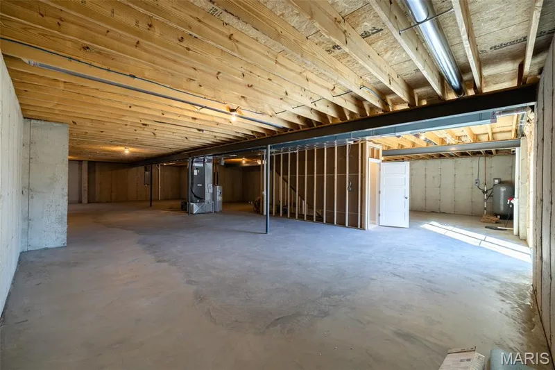 Unfinished below grade area featuring heating unit, a water pressure tank, and electric panel — 300 Schaper Estates Xing, Foristell, MO 63348