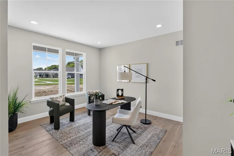 Den featuring two large windows, wood-finish flooring, recessed lighting, and light gray wall paint — 126 Royal Troon Drive, Dardenne Prairie, MO 63368