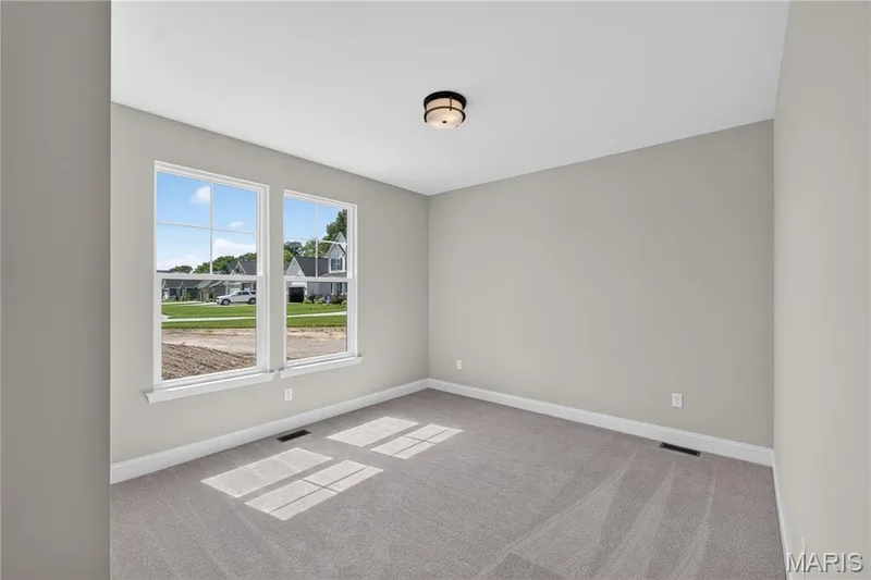 Bedroom 2 featuring a flush-mount ceiling light, light gray carpeting, and closet — 126 Royal Troon Drive, Dardenne Prairie, MO 63368
