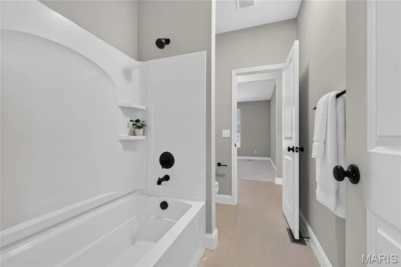 Jack-and-Jill Bathroom: Conveniently located between Bedrooms 2 and 3, featuring separate vanities and a shared shower. — 128 Royal Troon Drive, Dardenne Prairie, MO 63368