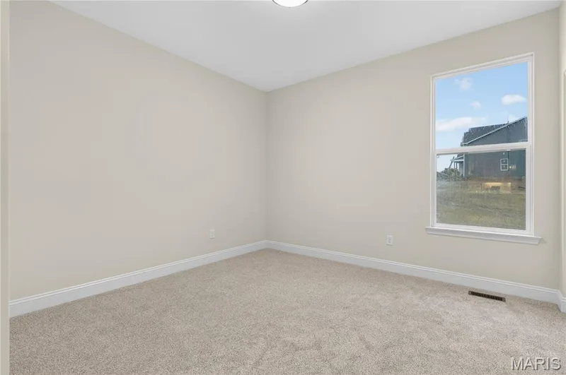 Bedroom with light beige walls and coordinating carpeting — 366 Strawberry Grove Drive, O'Fallon, MO 63376
