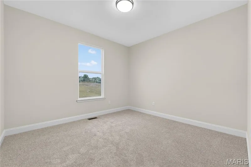 Bedroom featuring light beige walls and complementing carpeting — 366 Strawberry Grove Drive, O'Fallon, MO 63376