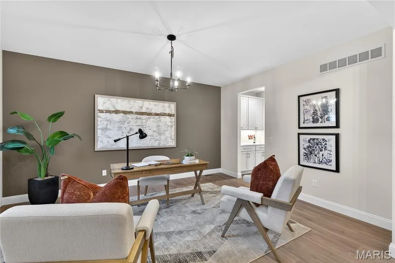 Dining room featuring wood-finish flooring, a contemporary chandelier, and a recessed ceiling vent, with access to Butlers Pantry — 369 Strawberry Grove Drive, O'Fallon, MO 63376