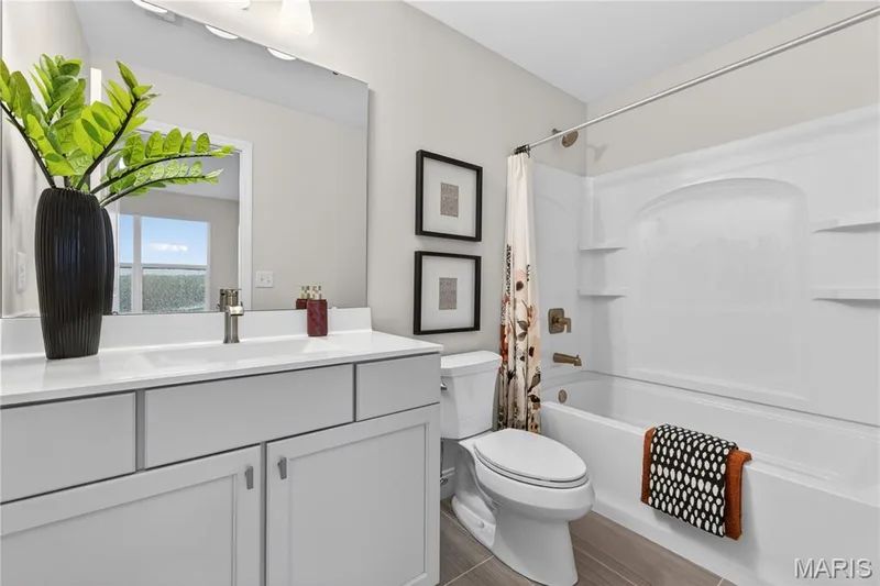 Bathroom featuring a single vanity with light grey cabinetry and a white countertop — 369 Strawberry Grove Drive, O'Fallon, MO 63376
