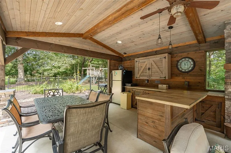Cabana features refrigerator, tv, fireplace and bar — 51 Nordic Lane, Defiance, MO 63341