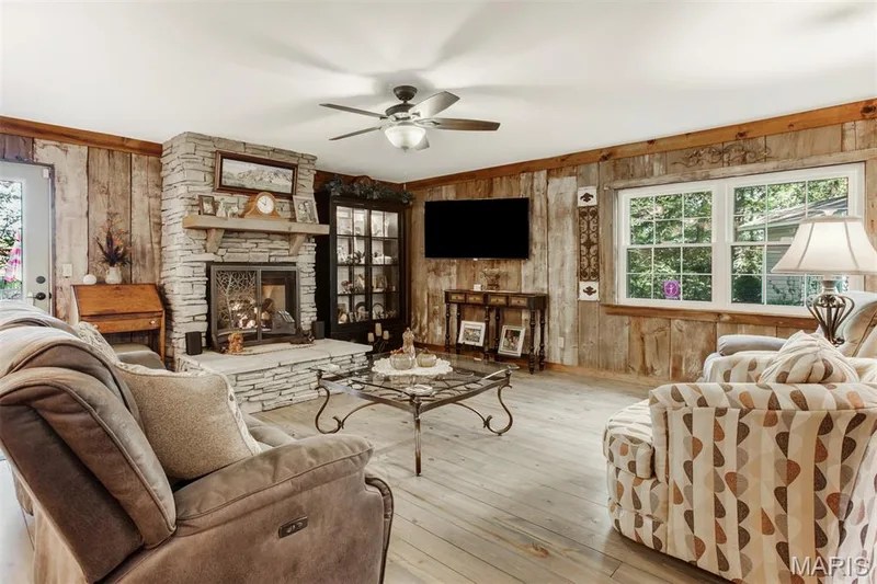 Family room features genuine barnwood walls — 51 Nordic Lane, Defiance, MO 63341