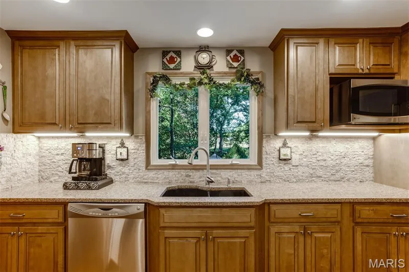 Kitchen window looks out to woods and pool area — 51 Nordic Lane, Defiance, MO 63341