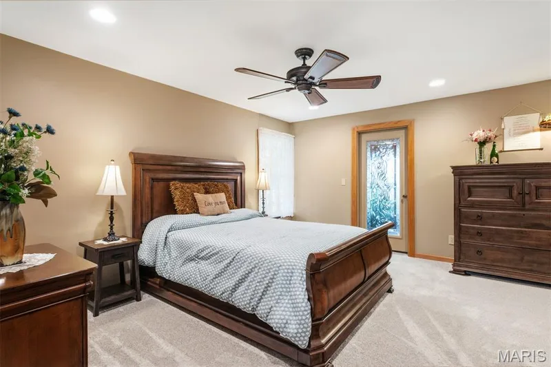 Primary bedroom, glass door opens to sunroom — 51 Nordic Lane, Defiance, MO 63341