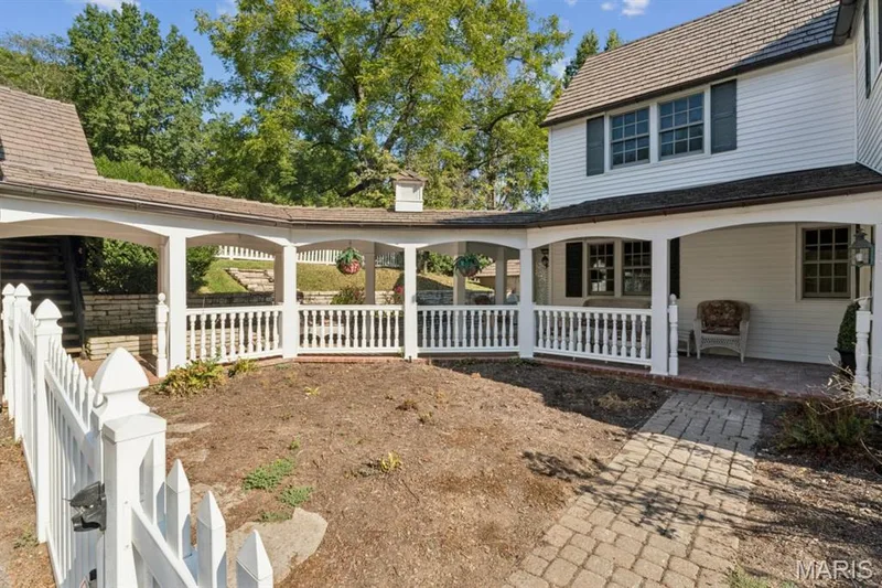 White picket fence entry leading to a brick paver walkway — 2333 Ossenfort Road, Wildwood, MO 63038