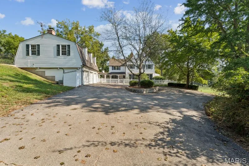 Expansive paved driveway leading to a three-car garage and a separate two-story structure with dormer windows — 2333 Ossenfort Road, Wildwood, MO 63038
