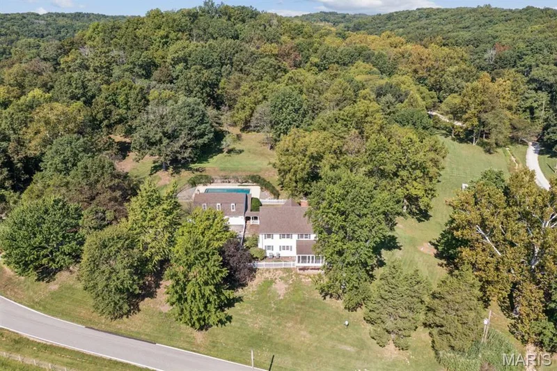 Two-story residential structure featuring a white exterior, dark roof, and a rear deck — 2333 Ossenfort Road, Wildwood, MO 63038