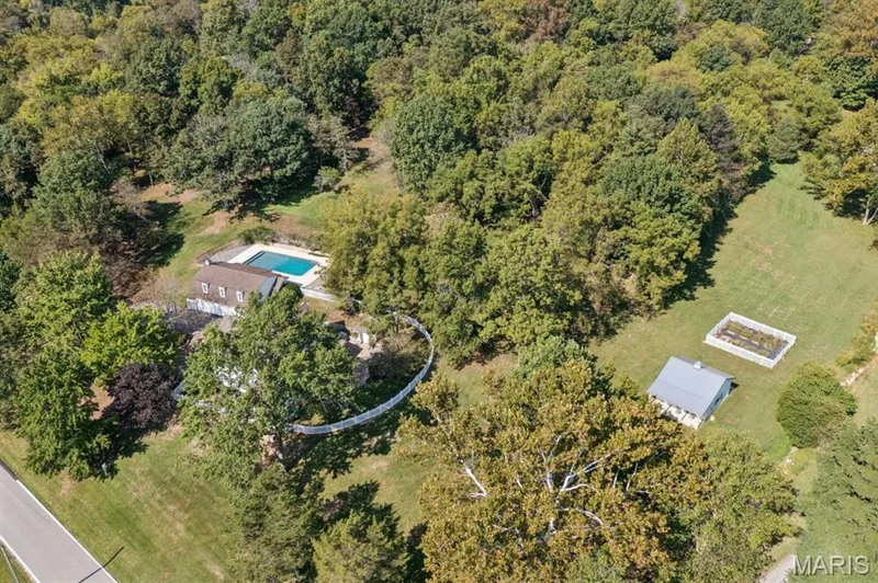 Expansive property featuring an in-ground swimming pool, a detached outbuilding, and a fenced garden area — 2333 Ossenfort Road, Wildwood, MO 63038