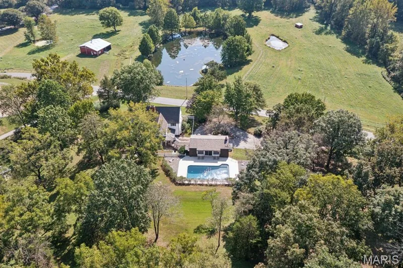 Expansive property featuring a private swimming pool, mature trees, a detached barn, and two ponds — 2333 Ossenfort Road, Wildwood, MO 63038