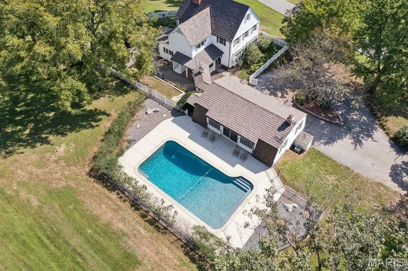 In-ground swimming pool with integrated steps, surrounded by a paved deck — 2333 Ossenfort Road, Wildwood, MO 63038