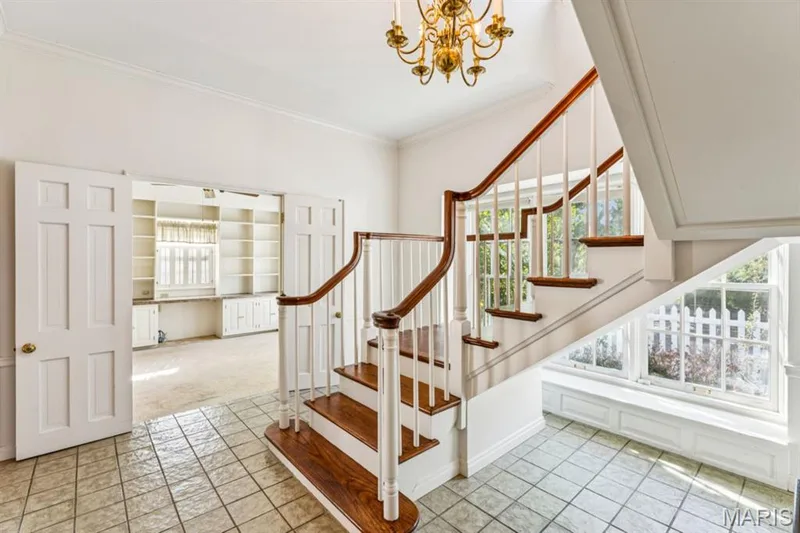 Tiled flooring entryway with a grand staircase featuring wood treads and white risers — 2333 Ossenfort Road, Wildwood, MO 63038