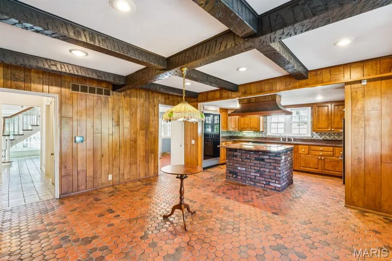 Exposed ceiling beams, recessed lighting, wood paneling, brick kitchen island, and hexagonal floor tiling — 2333 Ossenfort Road, Wildwood, MO 63038