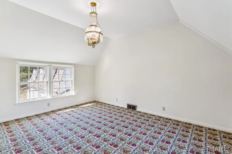 Vaulted ceiling room with patterned wall-to-wall carpeting and multiple windows — 2333 Ossenfort Road, Wildwood, MO 63038