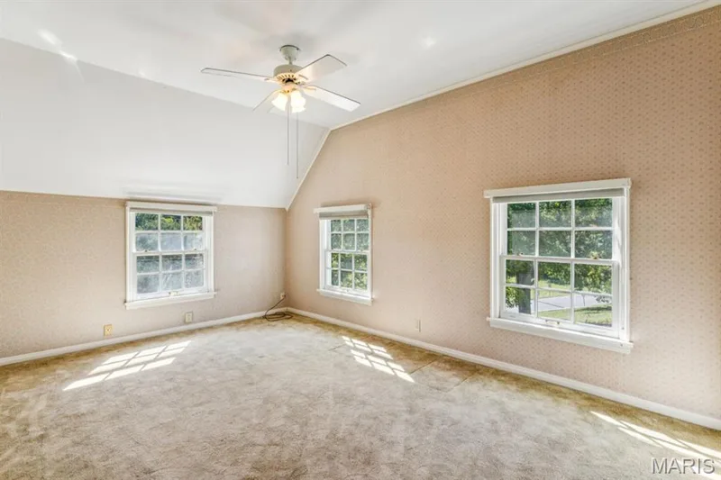 Vaulted ceiling with a ceiling fan, three multi-pane windows, and wall-to-wall carpeting — 2333 Ossenfort Road, Wildwood, MO 63038