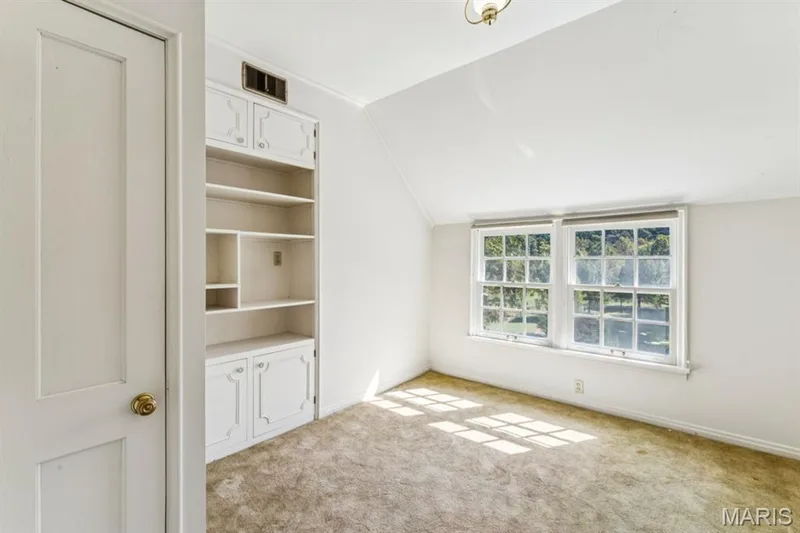 Built-in cabinetry with shelving and lower storage, dual sash windows, and ceiling-mounted lighting — 2333 Ossenfort Road, Wildwood, MO 63038