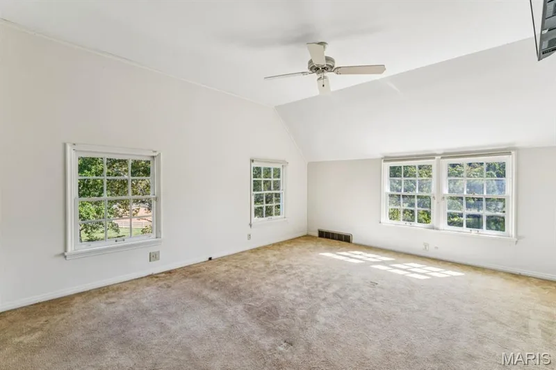Bright room with four multi-pane windows, a sloped ceiling, and a ceiling fan — 2333 Ossenfort Road, Wildwood, MO 63038