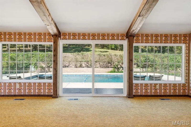 Exposed wood beams, two large picture windows, sliding glass door, and outdoor pool — 2333 Ossenfort Road, Wildwood, MO 63038
