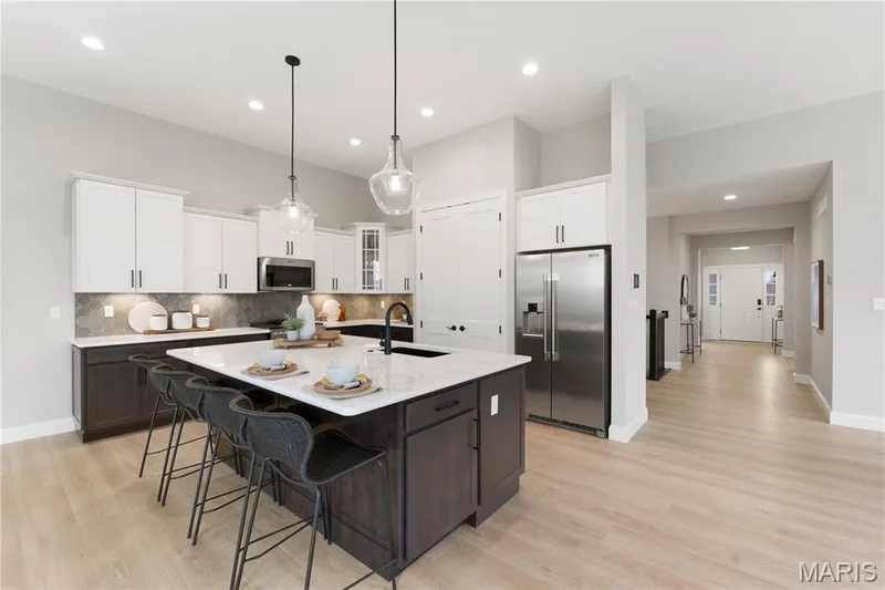 Luxury Kitchen with custom cabinets, large island with sink and Stainless steel gas appliances — 325 Healthy Way, St Charles, MO 63304