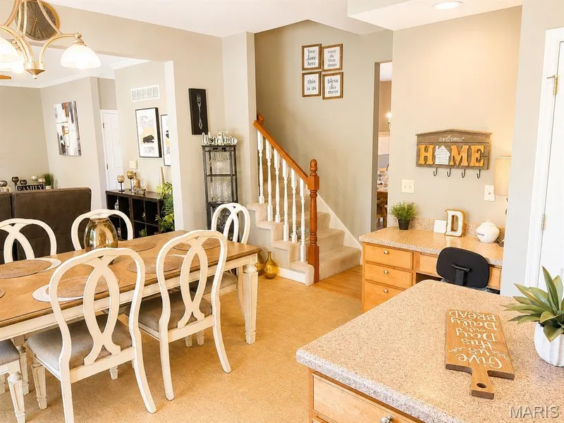 Dining area featuring a wood-finish table, recessed lighting, and an adjacent built-in desk area with a light-colored countertop — 1126 Manor Cove Drive, St Charles, MO 63304