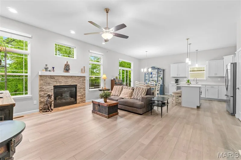 Spacious Great Room w/ lots of windows, gas fireplace, ceiling fan and recessed lighting — 1010 Timber Bluff Drive, Wentzville, MO 63385
