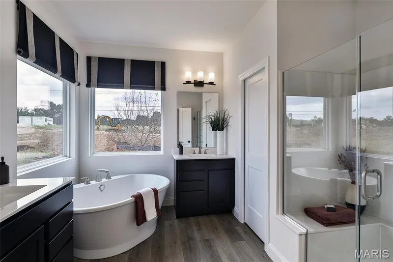 Luxury Primary Bathroom with Culture Marble Shower, Double Rectacular Wave bowls, and soaking tub — 128 Cedarstone Drive, Dardenne Prairie, MO 63368