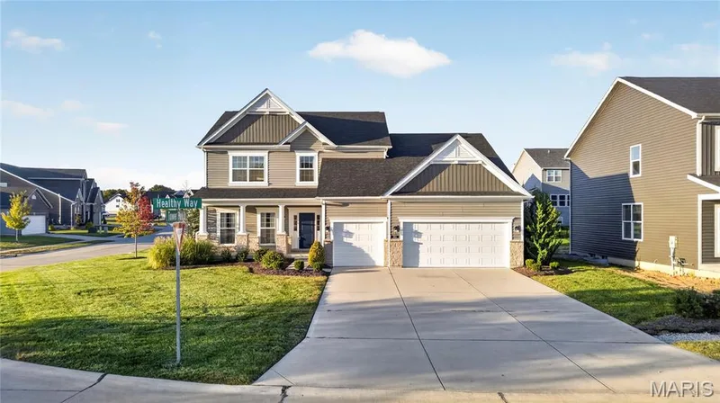 1.5 Story residence featuring a dark gray roof, light gray siding, and stone accents — 301 Healthy Way, St Charles, MO 63304