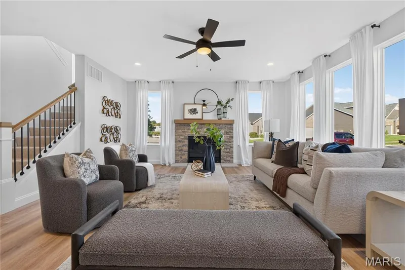 Gather around the beautiful stone-surround fireplace in this bright, open living space. — 301 Healthy Way, St Charles, MO 63304