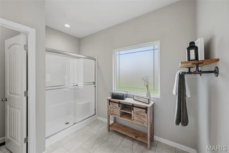 Seated shower with large window for natural light to flood the room — 411 Knothole Lane, Wentzville, MO 63385