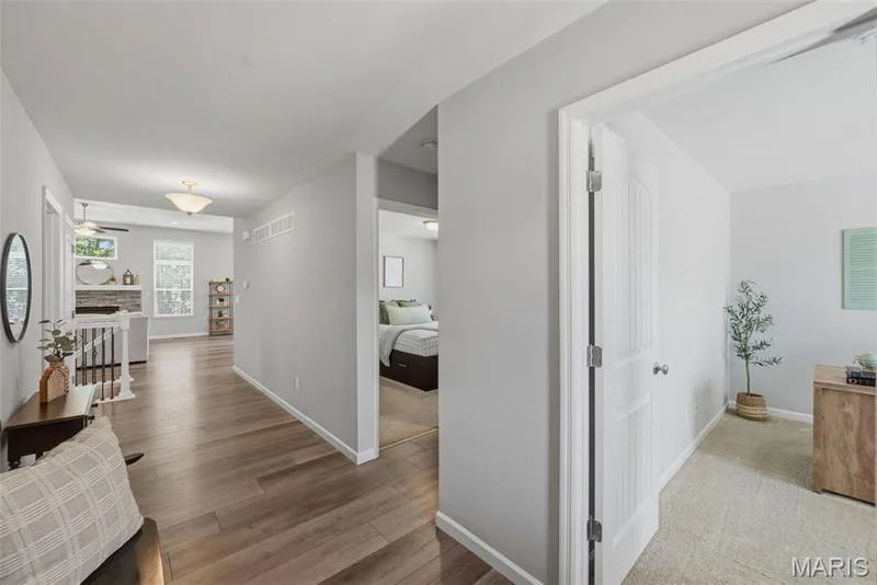Entry with bedrooms looking into open living room — 411 Knothole Lane, Wentzville, MO 63385