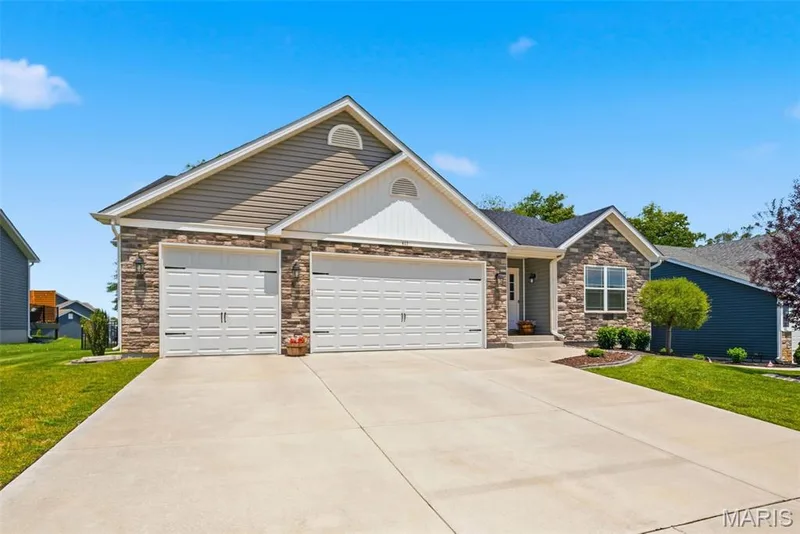 3 car garage with oversized driveway — 411 Knothole Lane, Wentzville, MO 63385