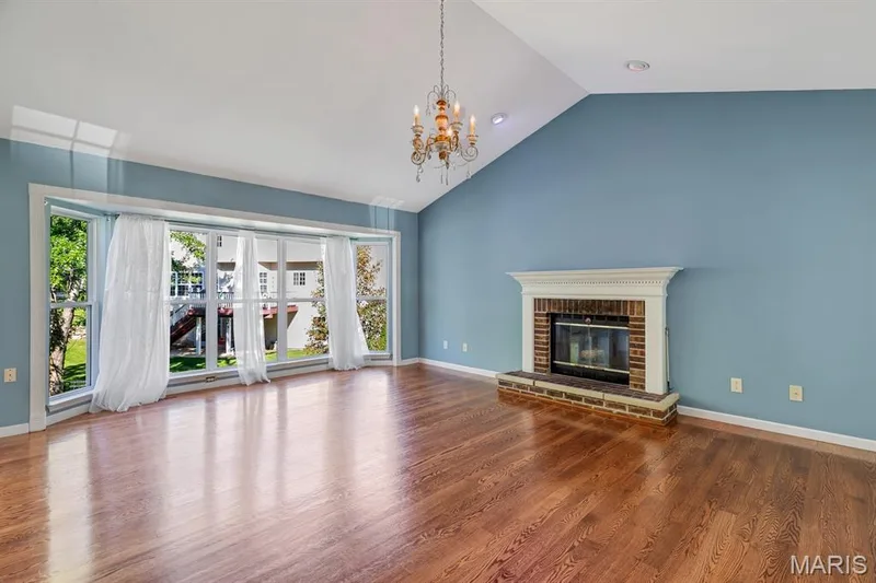 Spacious room featuring a vaulted ceiling and wood-finish flooring, 5 bay window and room for the whole family to gather! — 1103 Panda Court, Wentzville, MO 63385