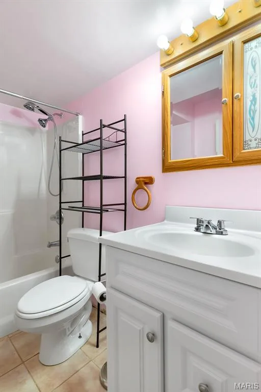 lower lebel Bathroom featuring a white vanity with an integrated sink, chrome faucet, and wood-framed mirrored medicine cabinet — 1103 Panda Court, Wentzville, MO 63385