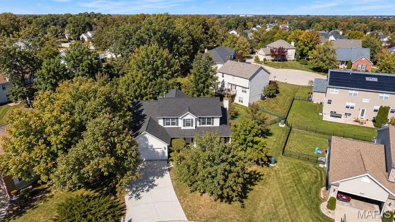 Two-story residence with a dark shingle roof, attached garage, and a concrete driveway — 1103 Panda Court, Wentzville, MO 63385