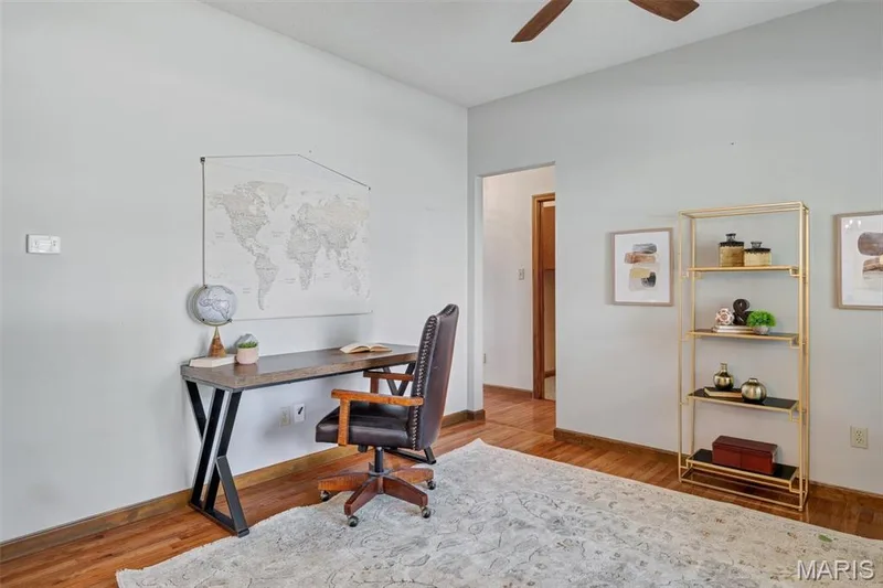 Bright interior space featuring wood-finish flooring and a ceiling fan — 195 England Drive, O'Fallon, MO 63366