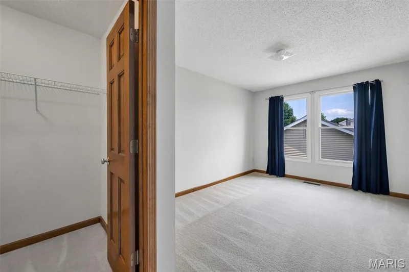 Upstairs bedroom with walk-in closet — 195 England Drive, O'Fallon, MO 63366