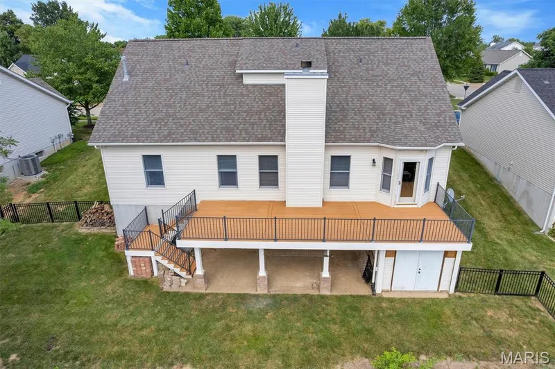 Beautiful large deck which covers the walk-out basement. There is also a large tuck-under storage area — 195 England Drive, O'Fallon, MO 63366
