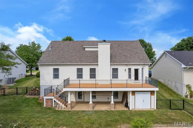 Beautiful large deck which covers the walk-out basement. There is also a large tuck-under storage area — 195 England Drive, O'Fallon, MO 63366