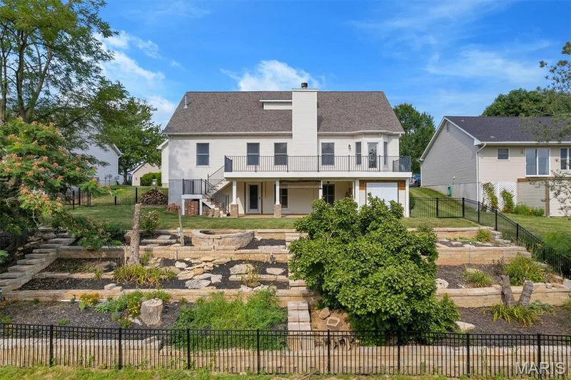 Rear exterior showcasing a multi-level terraced garden — 195 England Drive, O'Fallon, MO 63366