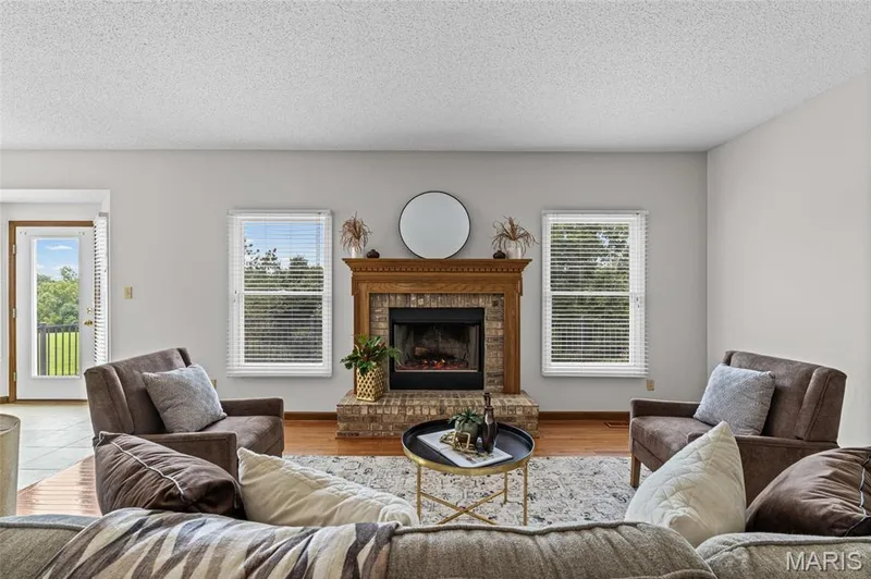 Brick fireplace with a wood mantle — 195 England Drive, O'Fallon, MO 63366