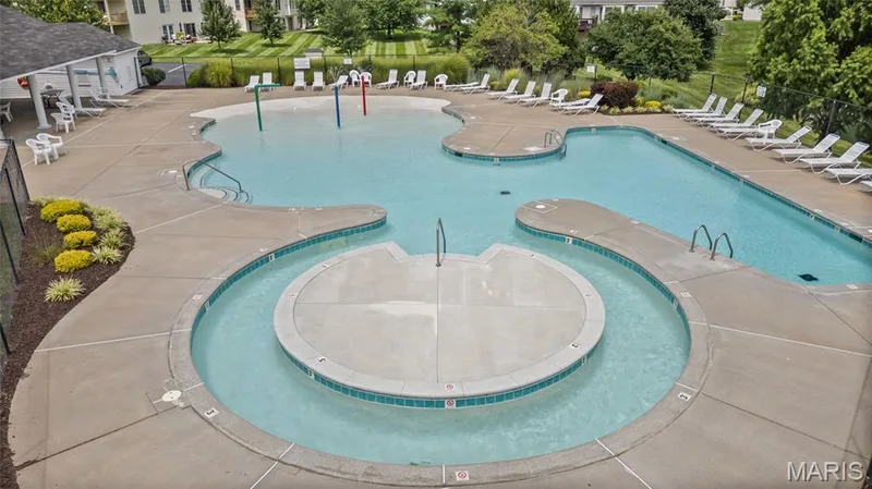 Expansive aquatic recreation area featuring a freeform swimming pool, integrated lazy river, and zero-entry wading section — 195 England Drive, O'Fallon, MO 63366
