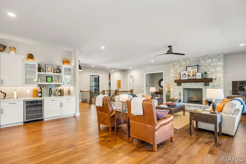 Looking towards the front of the home from the dining area - notice the stone woodburning fireplace — 4444 Augusta Shores Drive, Augusta, MO 63332