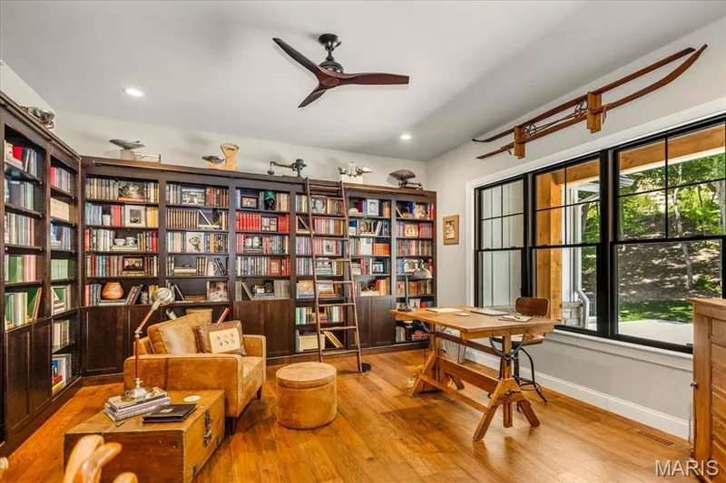 Library/Den at the front of the home.  Notice the ladder for those hard to reach books — 4444 Augusta Shores Drive, Augusta, MO 63332