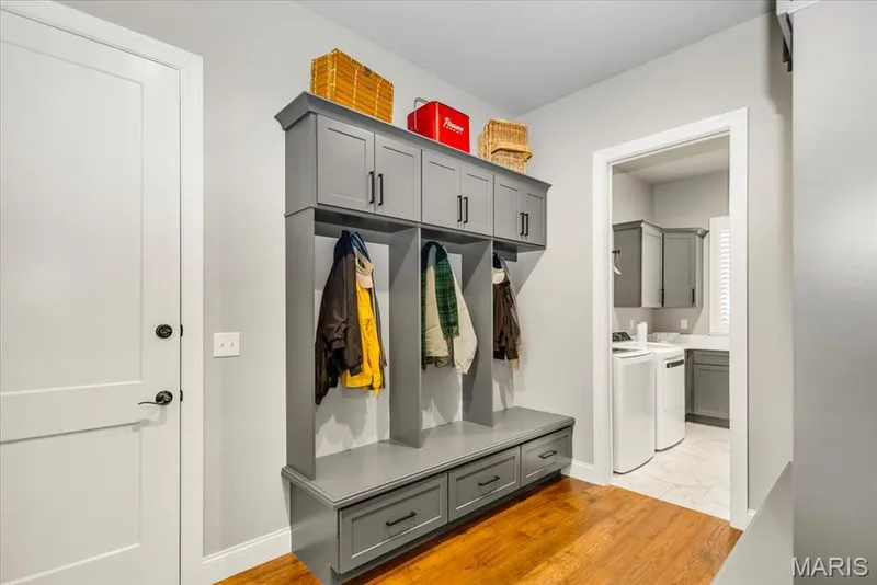 With a total of 6 cubbies in this mudroom between the garage entrance and the laundry room, everyone has a place to hang their coat/jackets — 4444 Augusta Shores Drive, Augusta, MO 63332