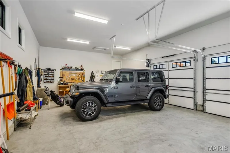 Oversized 2-car garage is the size of a 3-car garage.  Notice the windows on the back for natural light — 4444 Augusta Shores Drive, Augusta, MO 63332