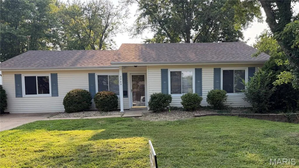 Charming single-story home featuring a classic siding exterior with a covered front porch, black shutters, and multiple windows providing natural light — 2505 Ambelwood Lane, O'Fallon, MO 63368